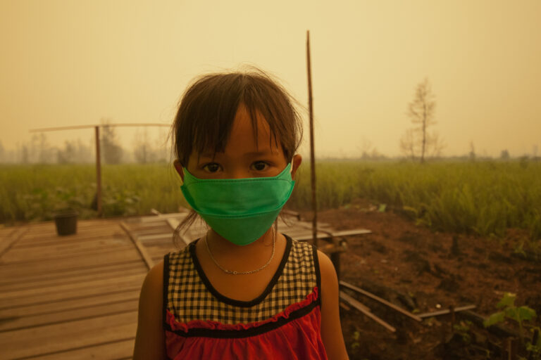 Children wear masks due to the toxic smoke from peat land fires, Central Kalimantan, Indonesia.