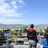 Ornithologist Hemanta Dhakal and his daughter look towards the runway of the Pokhara International Airport from their home in Majheripatan. Image by Abhaya Raj Joshi/ Mongabay.