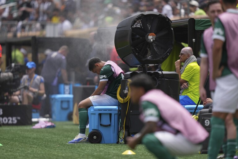 Palmeiras' Vitor Roque sits on the side of the pitch in a cooling mist after being substituted during the Club World Cup round of 16 soccer match between Palmeiras and Botafogo in Philadelphia, Sunday, June 29, 2025. (AP Photo/Matt Slocum, File)