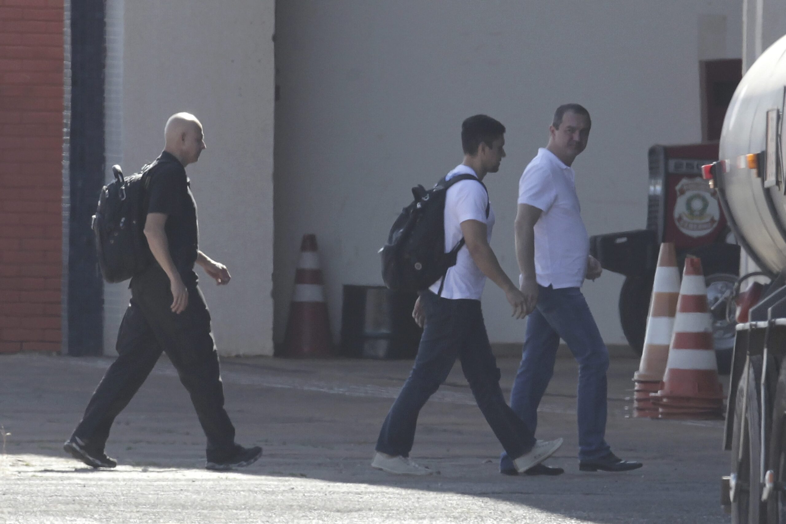 Joesley Batista, from the JBS meatpacking giant, right, arrives at the airport during his transfer to a federal police jail after he turned himself in to authorities in Brasília, Brazil, in 2017. Image by AP Photo/Eraldo Peres.