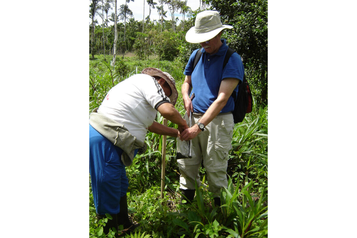 Thomas Rudel at the research site in Ecuador with a research assistant measuring a tree seedling that in a few short years will help to convert this pasture into a silvopasture, an instance of reforestation that gets a chapter in the book. Photo courtesy of Rudel.