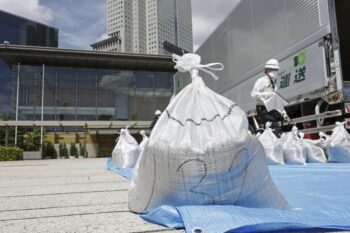 A bag of soil, slightly radioactive but decontaminated one from Fukushima, is delivered to the Japanese prime minister's office to be reused in the garden, in Tokyo, Japan, Saturday, July 19, 2025. (Kyodo News via AP)