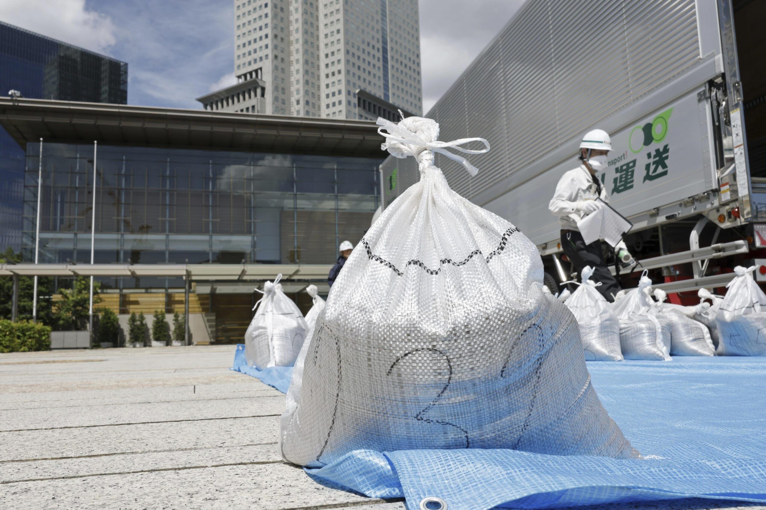 A bag of soil, slightly radioactive but decontaminated one from Fukushima, is delivered to the Japanese prime minister's office to be reused in the garden, in Tokyo, Japan, Saturday, July 19, 2025. (Kyodo News via AP)