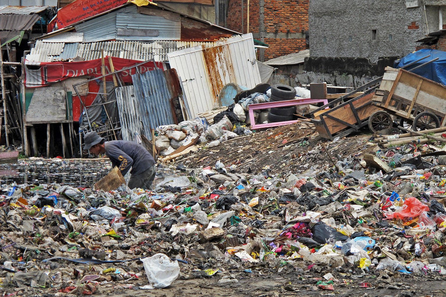 A man sifts through garbage in Jakarta.