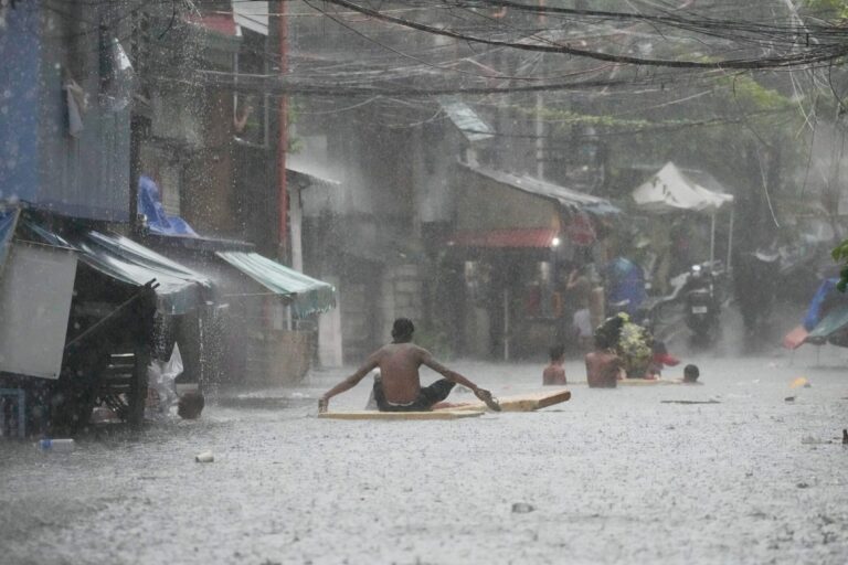 Banner image of a heavy downpour after Tropical Storm Wipha caused intensified monsoon rains in Quezon City, Philippines, on July 21. Image by AP Photo/Aaron Favila.