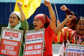 Indigenous Lumad women hold slogans during a rally outside a military headquarters in the Philippines in 2018