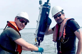 Researchers Dušan Materić, left, and Helge Niemann, right, collecting water samples in the North Atlantic Ocean. Image courtesy of NIOZ.