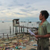 Resident Huỳnh Ngọc Vân at his old seaside home, surrounded by demolished houses cleared for the project, late April 2025.