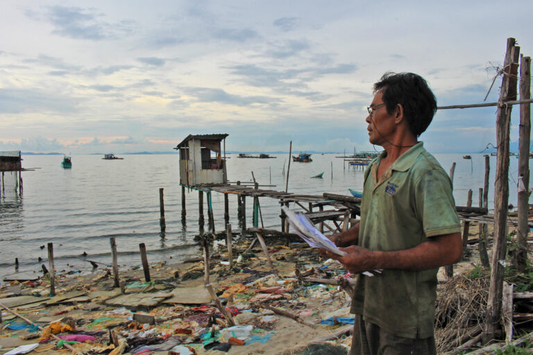Resident Huỳnh Ngọc Vân at his old seaside home, surrounded by demolished houses cleared for the project, late April 2025.