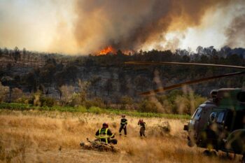 This photo provided by the Securite Civile on Friday, Aug.8, 2025 shows firefighters next to a wildfire Thursday, Aug. 7, 2025 near Jonquieres, southern France. (Securite Civile via AP)