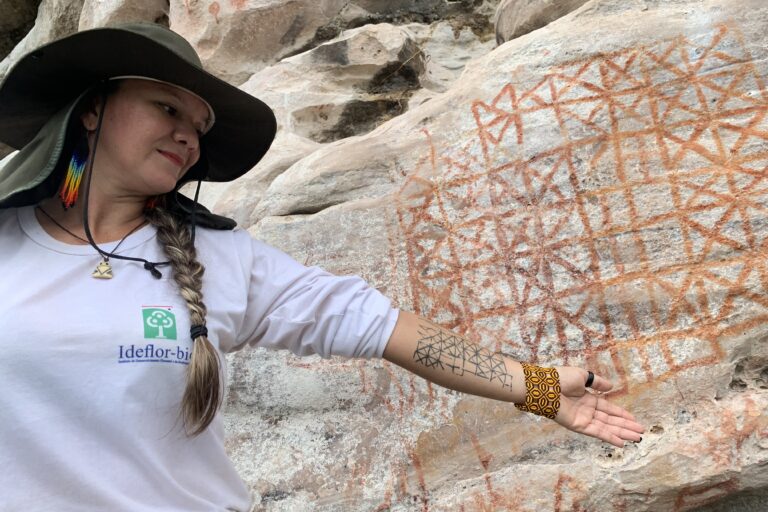 Park guide Luana Wanessa Assunção points at the remarkable Painel do Pilão, which could be the first-ever solar calendar of the Americas. Image by Peter Speetjens.