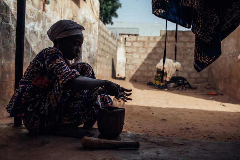 A woman in Nigeria prepares food.