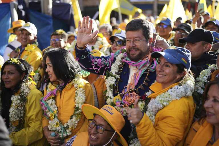 Presidential candidate Samuel Doria Medina, center, waves to supporters while campaigning, five days ahead of presidential elections. (AP Photo/Natacha Pisarenko)