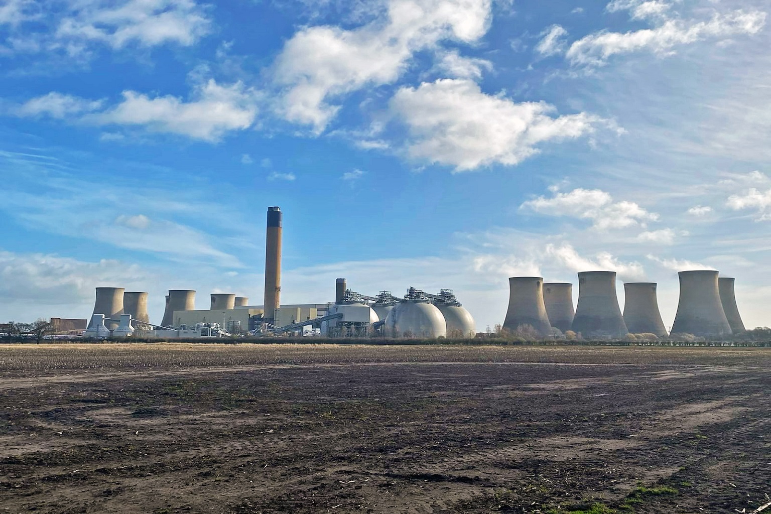 England’s Drax power plant burns millions of tons of wood pellets annually, and contributed 13.3 million metric tons of CO₂-equivalent smokestack emissions to the atmosphere in 2024, according to one source — emissions counted by the U.K. and the company as zero. Drax is the largest biomass-only energy plant on Earth and has received billions in green subsidies from the U.K. government over the past 15 years, though the subsidies will be reduced in 2027.