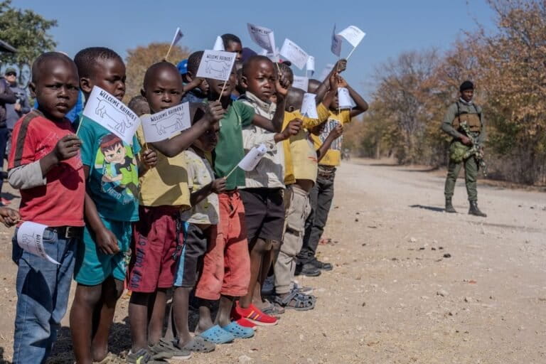 Children cheering the arrival of two new rhinos into their community rhino conservation program. The community is set to benefit from the tourism these rhinos will generate. Image courtesy of James Ward / Rewild Safaris.