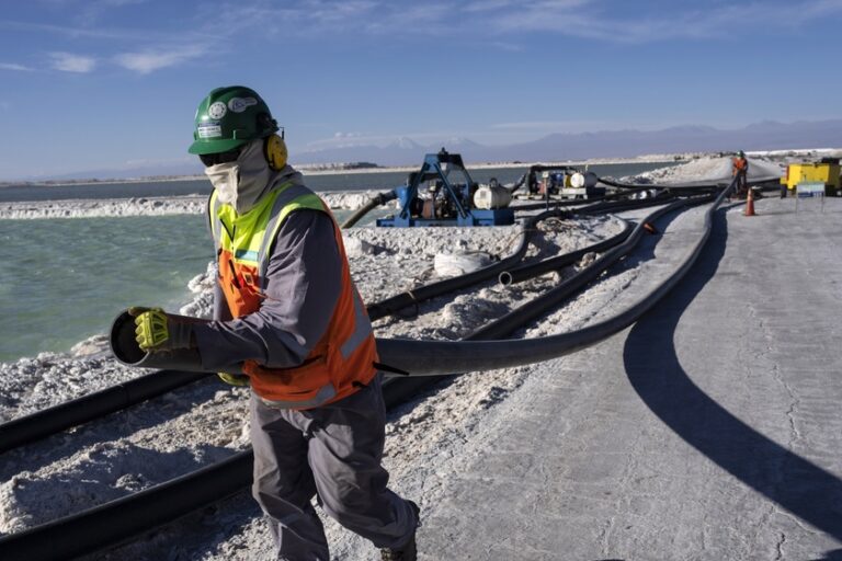 Workers perform maintenance next to pools of brine slowly turning into lithium at the Albemarle lithium mine in Chile's Atacama desert. Photo by: AP Photo/Rodrigo Abd.