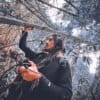 DJ Edwin Carrasco, known in the artistic world as Tayta Bird, recording sounds of a rainforest.