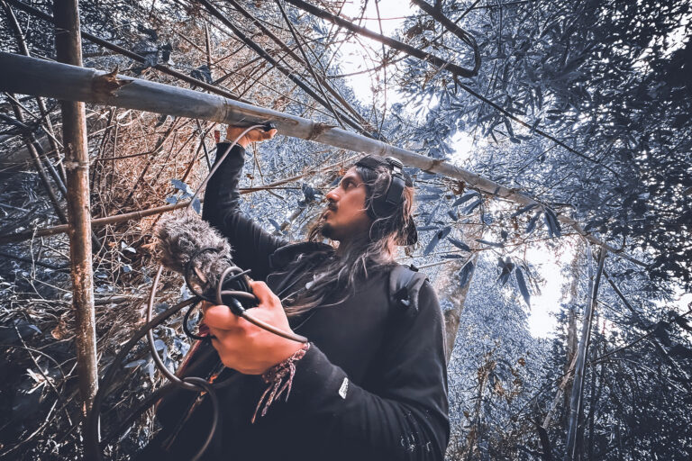 DJ Edwin Carrasco, known in the artistic world as Tayta Bird, recording sounds of a rainforest.