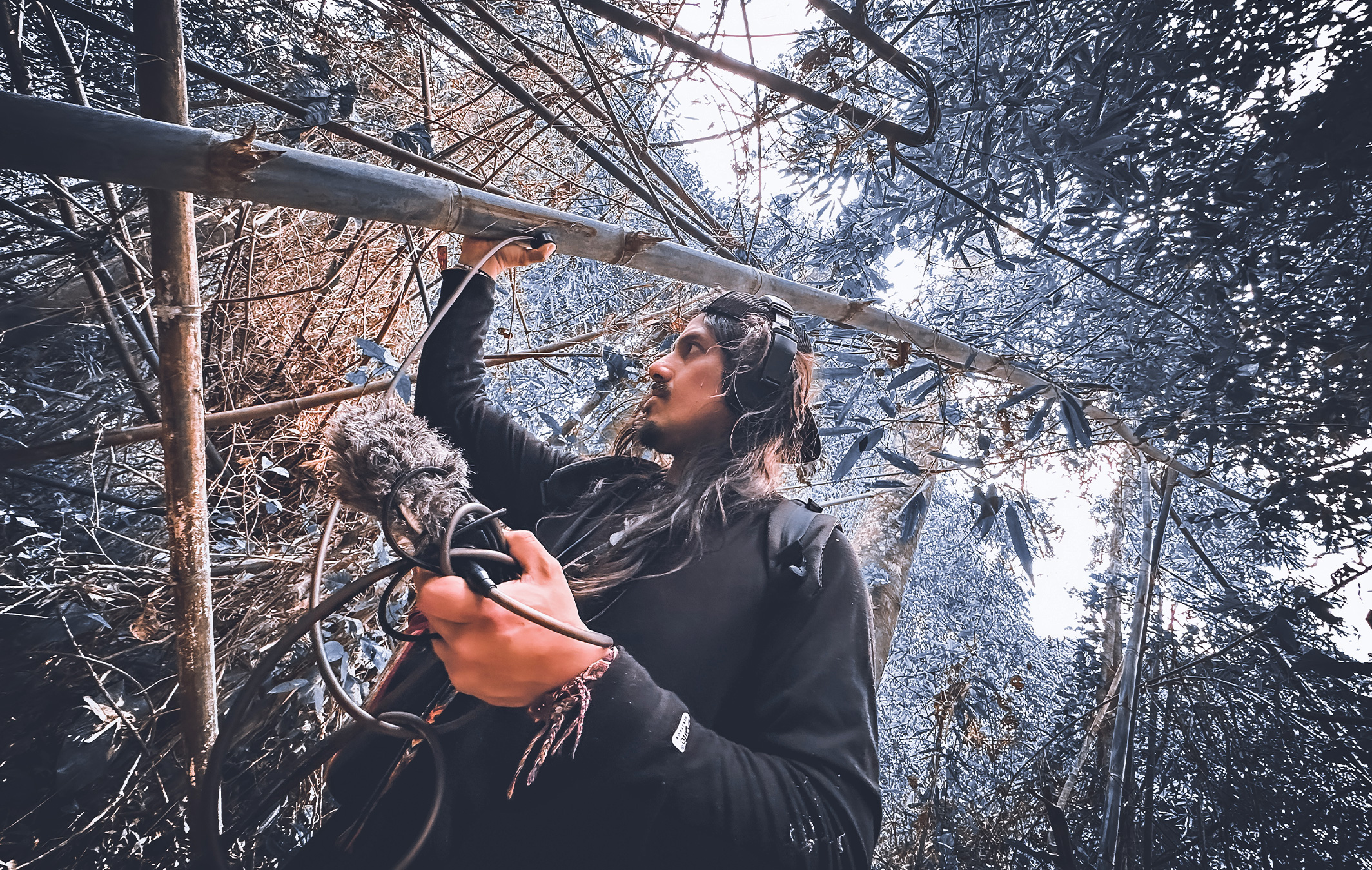 DJ Edwin Carrasco, known in the artistic world as Tayta Bird, recording sounds of a rainforest.