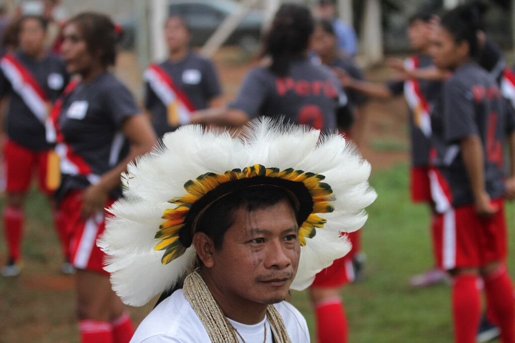 A Rikbaktsa Indigenous man watches a soccer game at the World Indigenous Games in Palmas, Brazil, 2015. His Escondido Indigenous Territory suffers pressure of deforestation from nearby ranches.