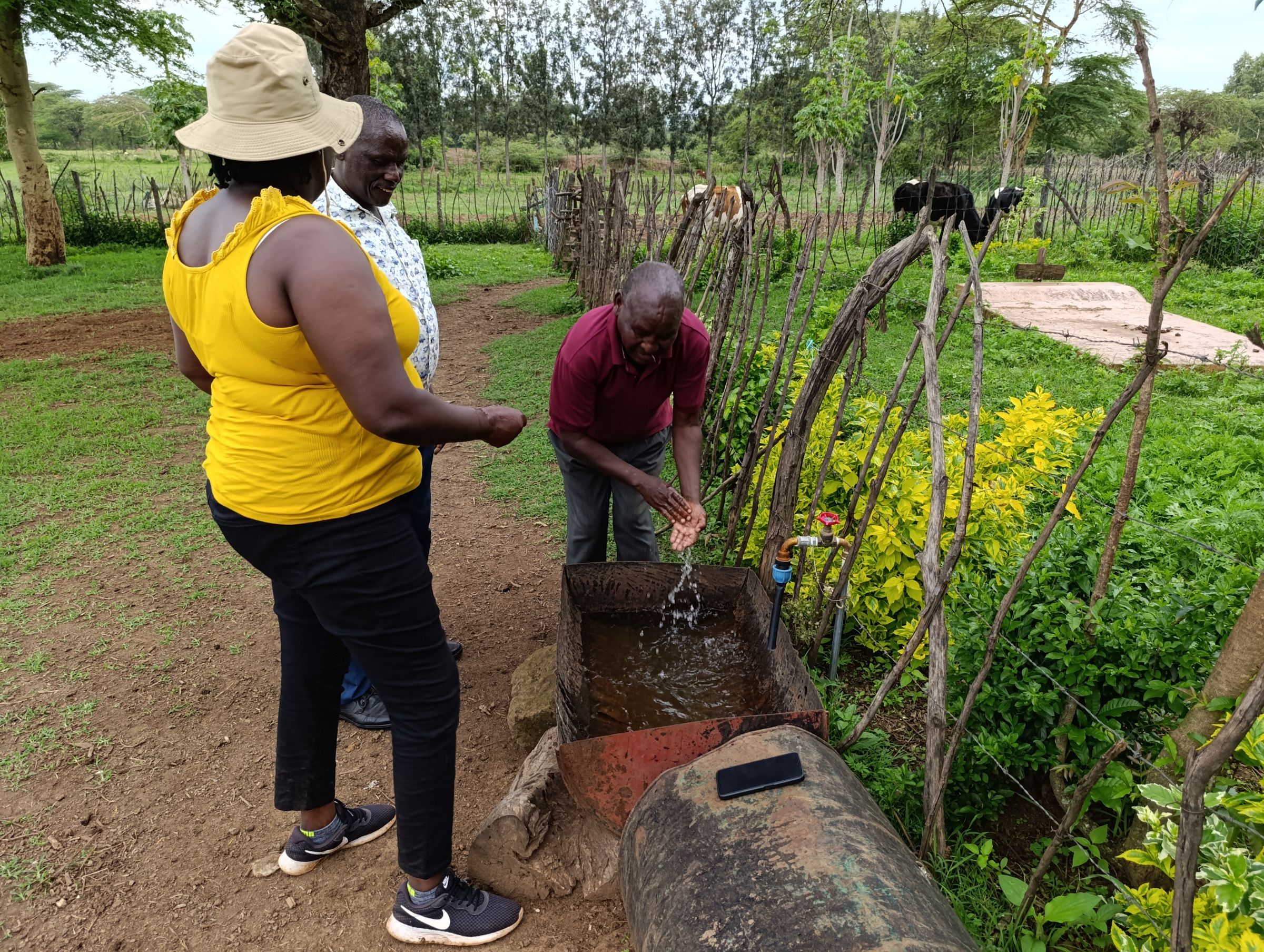 Indigenous Women and Girls Initiative lead Monica Yator (in yellow) in conversation with farmers in Baringo County. Image by Gilbert Nakweya for Mongabay.