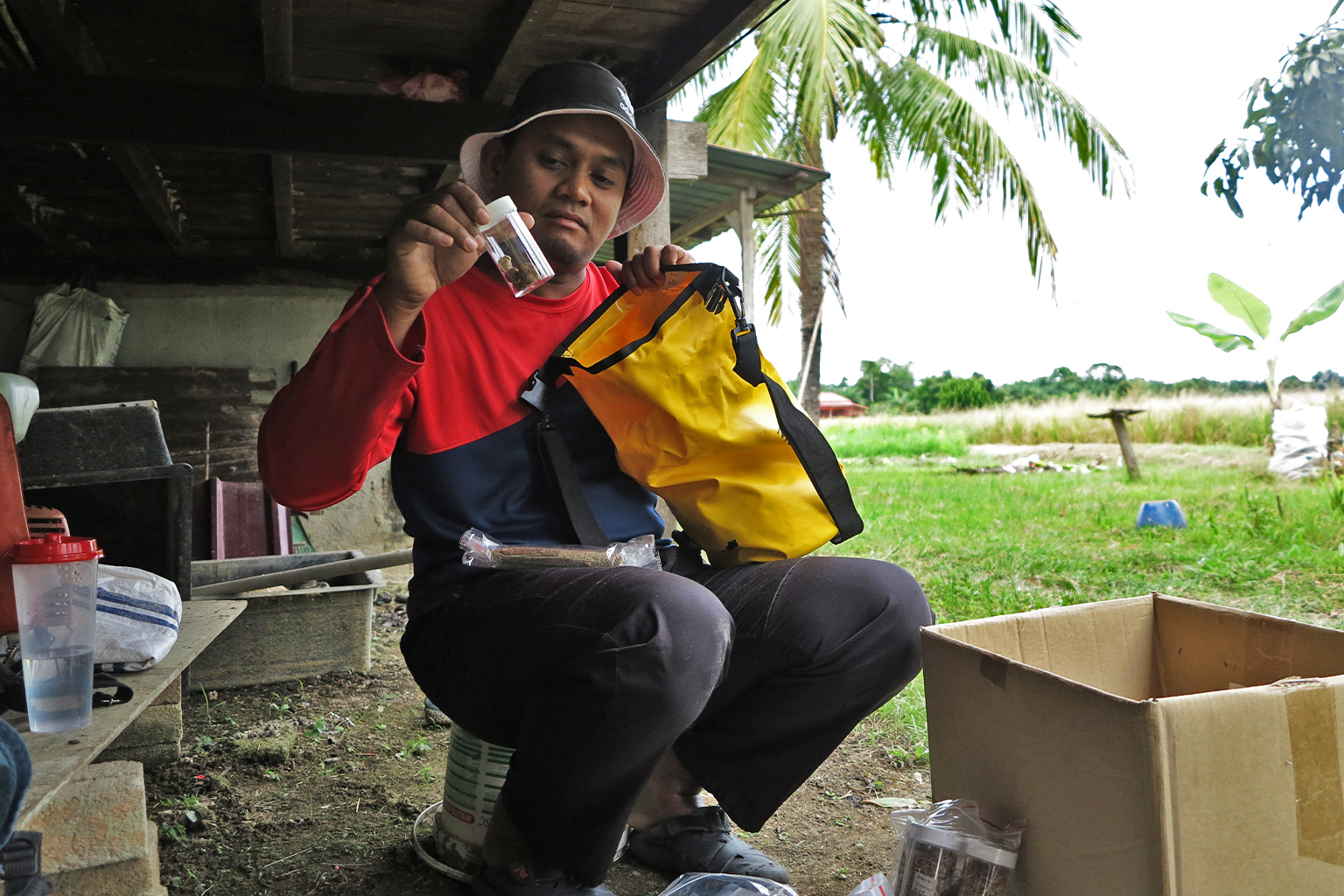 NurFitri Amir Muhammad showing his seeds collection.