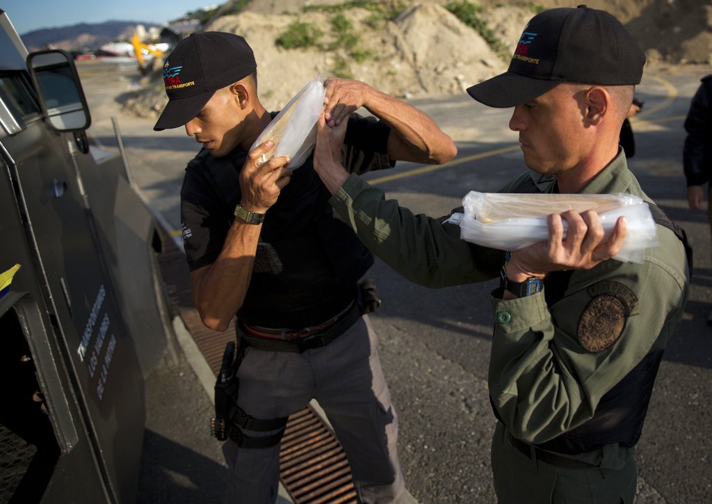 Members of a military agency that transports gold from the Orinoco mining belt in southern Bolivar state to Venezuela's Central Bank, at the Carlota military airport in Caracas, Venezuela. Photo by: AP Photo/Ariana Cubillos.
