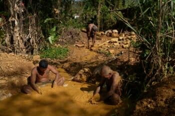 Miners pan for gold at a gold mine in El Callao, Bolivar state, Venezuela, Friday, April 28, 2023. Miners pan for hours in ponds where standing water fosters mosquitos that transmit diseases, such as malaria and dengue fever. Photo by: AP Photo/Matias Delacroix.