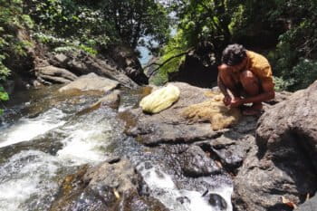 A fisher mends his net at Yettinahalla.