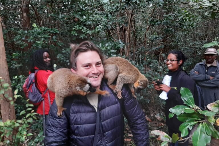 Willie Shubert in Madagascar with lemurs at a rehabilitation center. Note: visitors are not permitted to touch lemurs, but lemurs do as they please. Photo by Rhett Ayers Butler