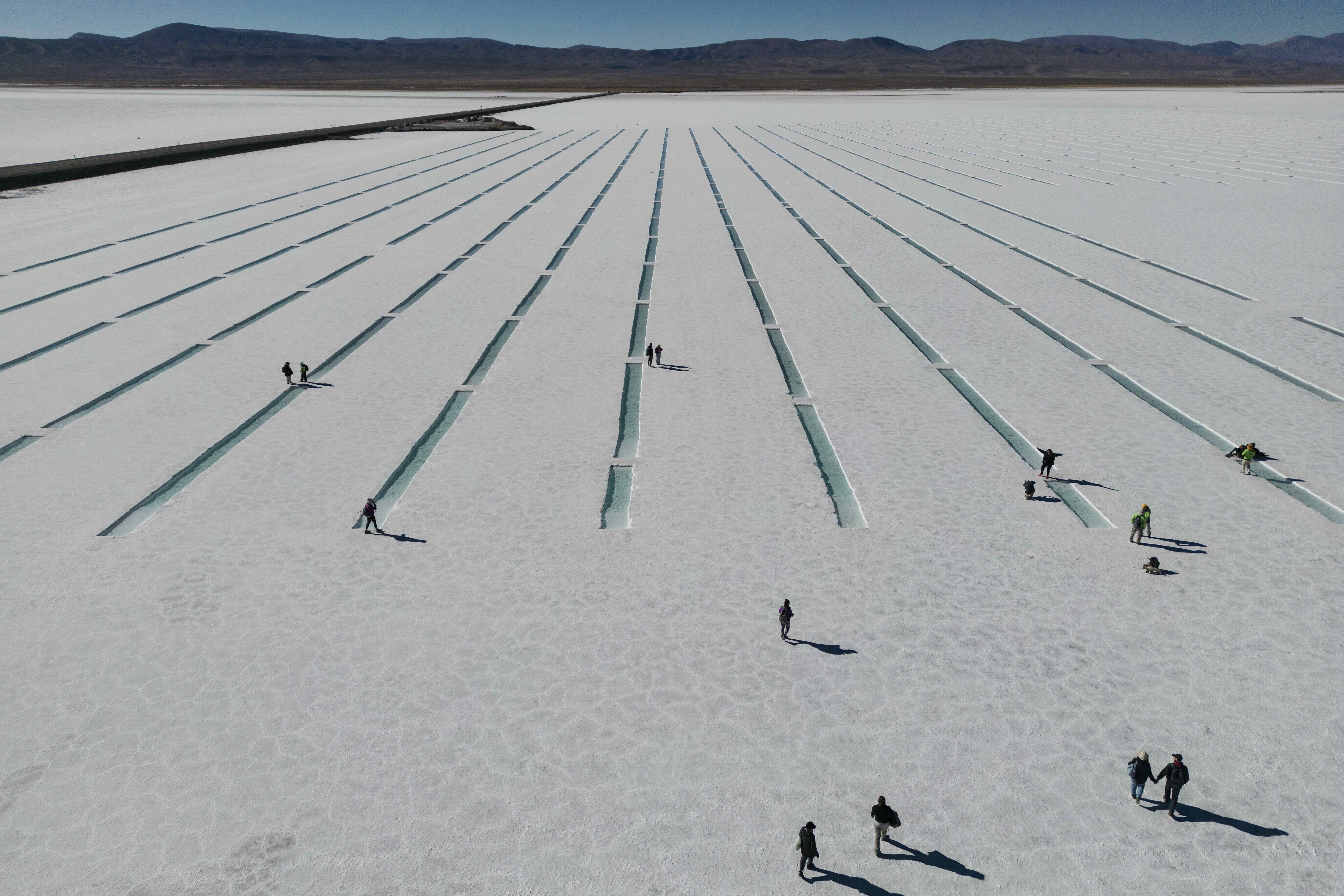 Tourists gather in the Salinas Grandes salt flats in Jujuy, Argentina, Tuesday, April 25, 2023. The salt flat brings income to towns through tourism and small-scale salt harvesting. (AP Photo/Rodrigo Abd)