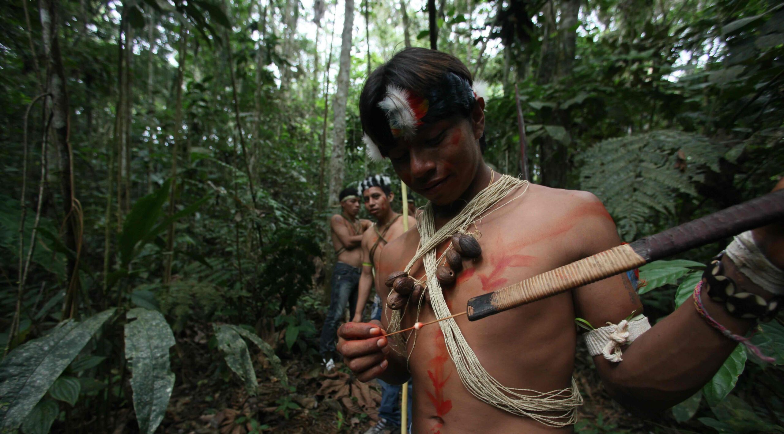 A Waorani indigenous youth prepares to use his blowpipe in Yasuni National Park in the Upper Napo Valley of the Western Amazon region in Ecuador, Saturday Aug. 21, 2010. Yasuni National Park, a UNESCO Biosphere Reserve since 1989 and home to the Tagaeri-Taromenane and Waorani indigenous communities, holds close to 1 billion barrels of crude. Image by AP Photo/Dolores Ochoa.