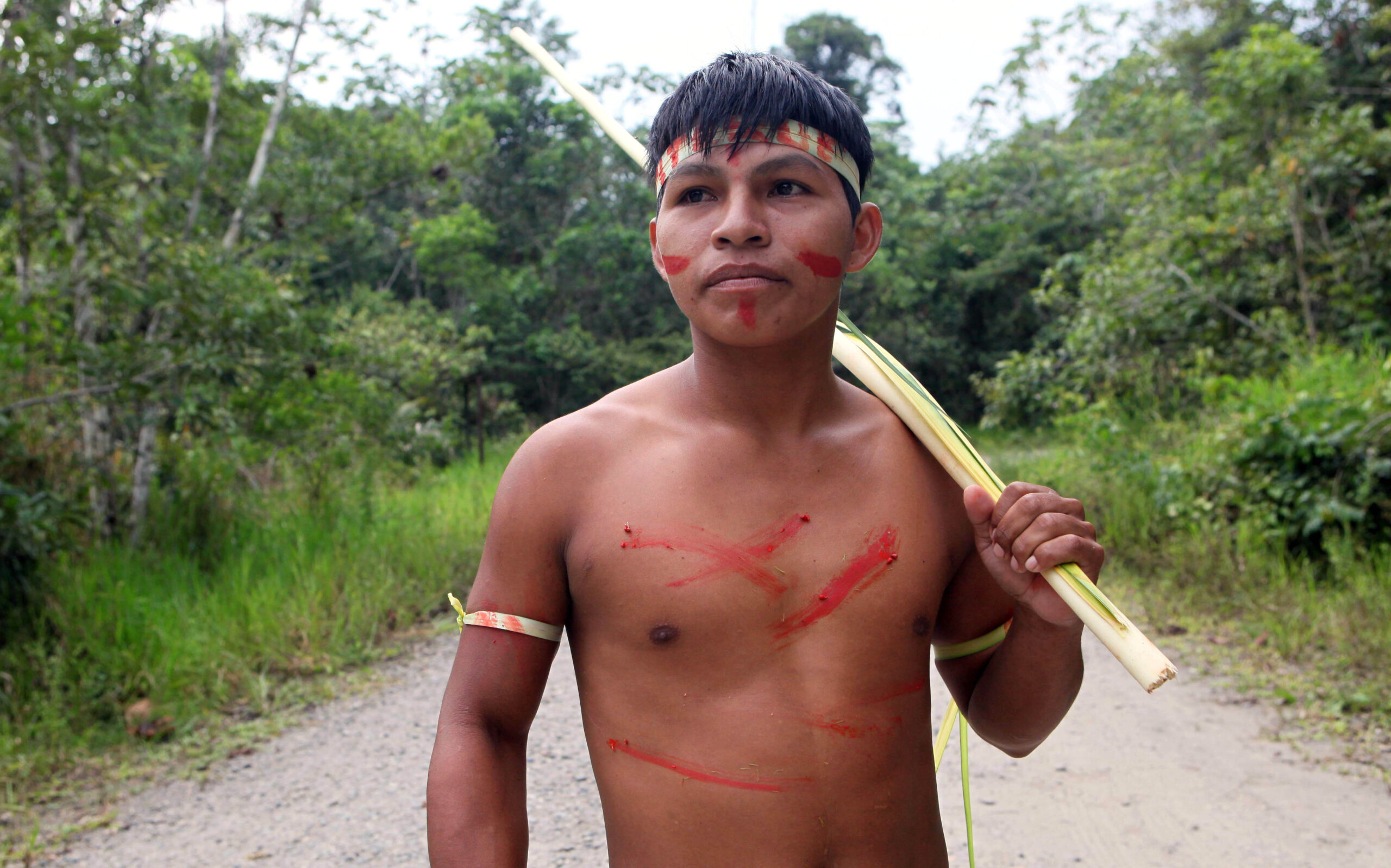 A young Waorani indigenous man stands in Yasuni National Park in the Upper Napo Valley of the Western Amazon region in Ecuador, Saturday Aug. 21, 2010. Yasuni National Park, a UNESCO Biosphere Reserve since 1989 and home to the Tagaeri-Taromenane and Waorani indigenous communities, holds close to 1 billion barrels of crude. Image by AP Photo/Dolores Ochoa.