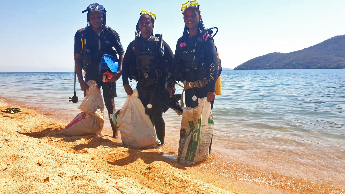 After a dive that lasted less than 30 minutes within an area no more than 30 meters (100 feet) from the beach, Felix Sinosi (left), Adina Ericas (center) and Geeta Ronald emerged with hauls of garbage.