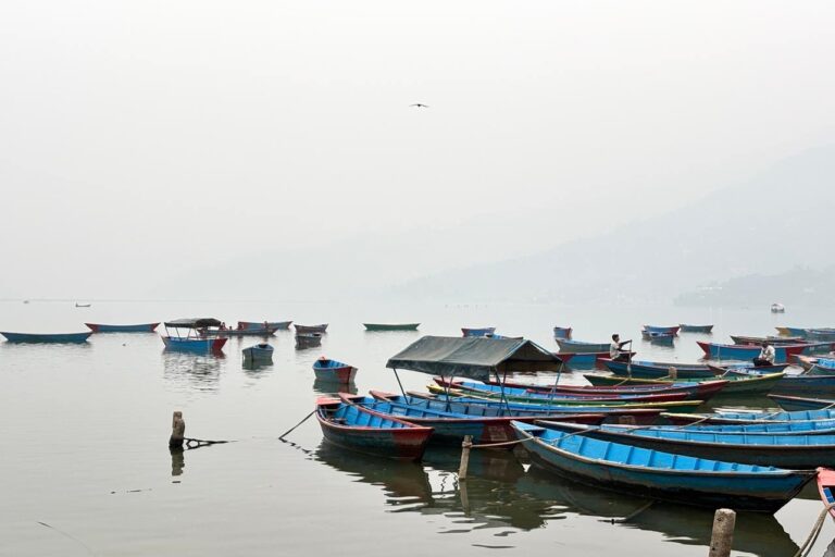 The iconic Phewa lake in Nepal's Pokhara shrouded in smog during the peak wildfire season. Image by Abhaya Raj Joshi/Mongabay.