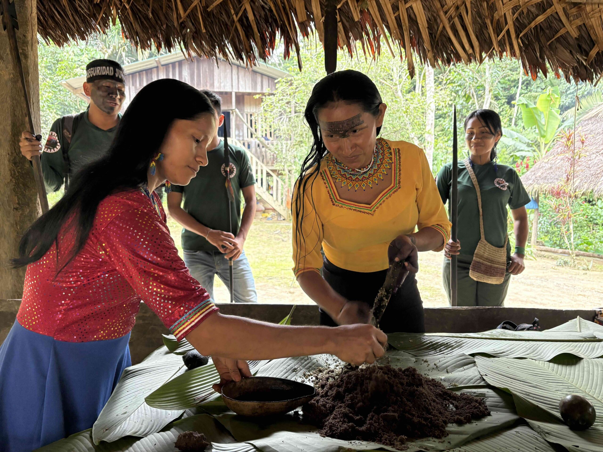 Women prepare wituk ink for dying hair and painting traditional designs on their skin. Image by Brandi Morin.