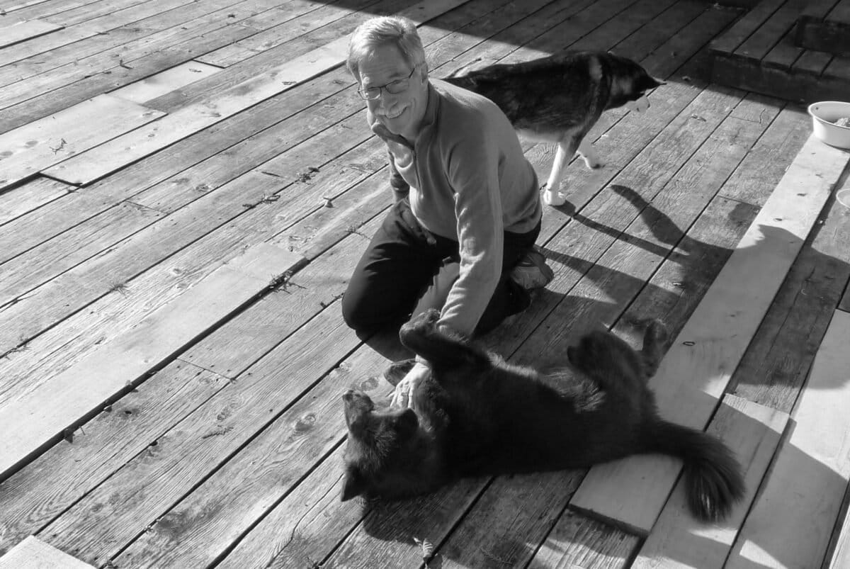 Chris Allnutt at the Heiltsuk First Nations' Koeye Lodge. The dogs are bear dogs to warn and protect the youth if there is a Grizzly bear coming into the camp. Image by Jens Wieting