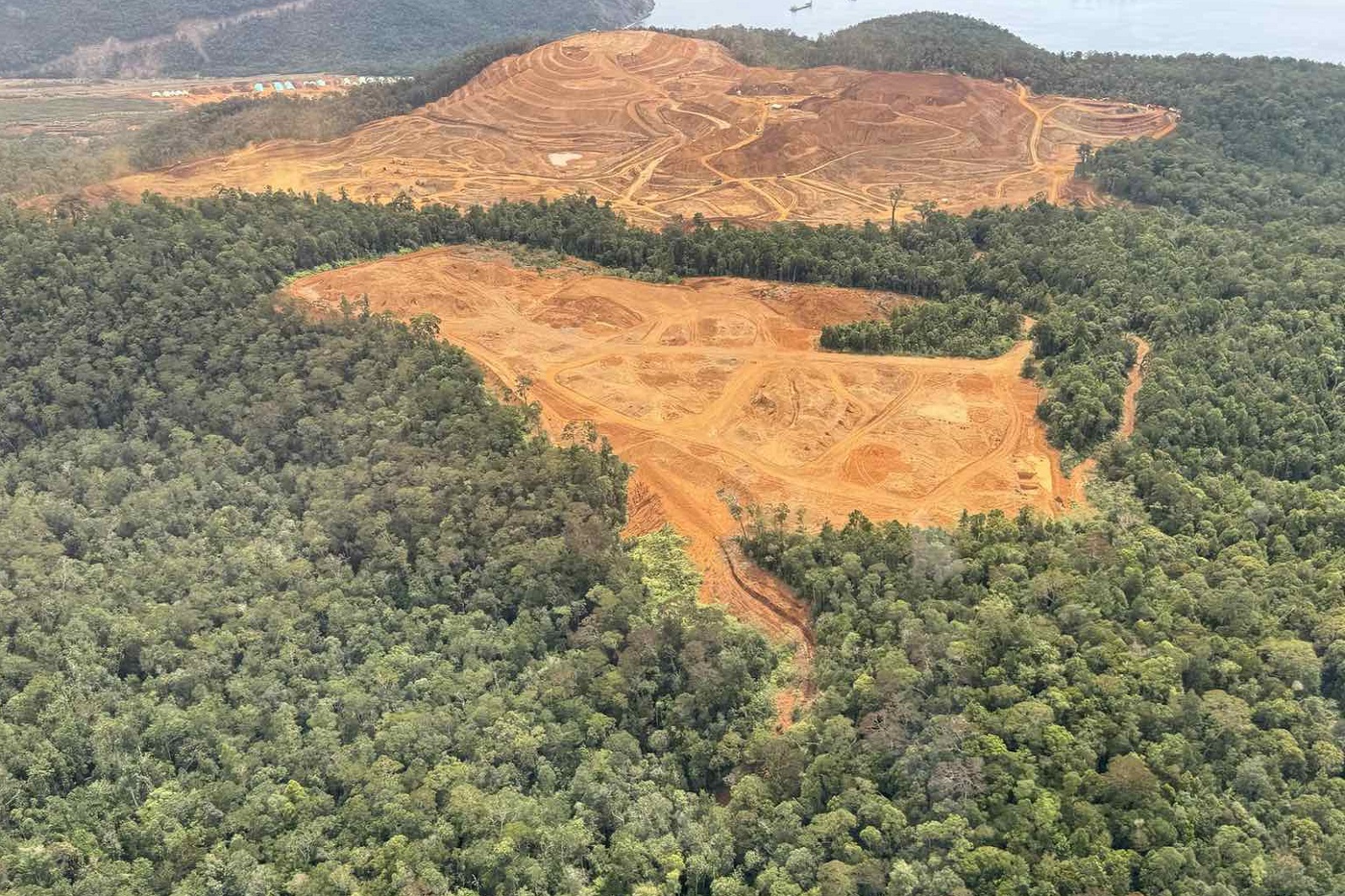 The Pujada Nickel Mining Project leaves an open-wide brown pit, sandwiched between the Mount Hamiguitan Range Wildlife Sanctuary and Pujada Bay.