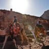 A Jordanian Bedouin boy leads a tourist on a camel through the ancient city of Petra, Jordan. World Cultural Heritage sites made out of stone are at risk from the effects of severe weather and climate change.