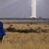 A shepherd watches livestock near Khi Solar One, a solar thermal plant that converts the sun's light energy into electricity, outside Upington, South Africa. Solar offers vast untapped potential in Africa. Image by AP Photo/Themba Hadebe.