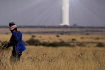 A shepherd watches livestock near Khi Solar One, a solar thermal plant that converts the sun's light energy into electricity, outside Upington, South Africa. Solar offers vast untapped potential in Africa. Image by AP Photo/Themba Hadebe.