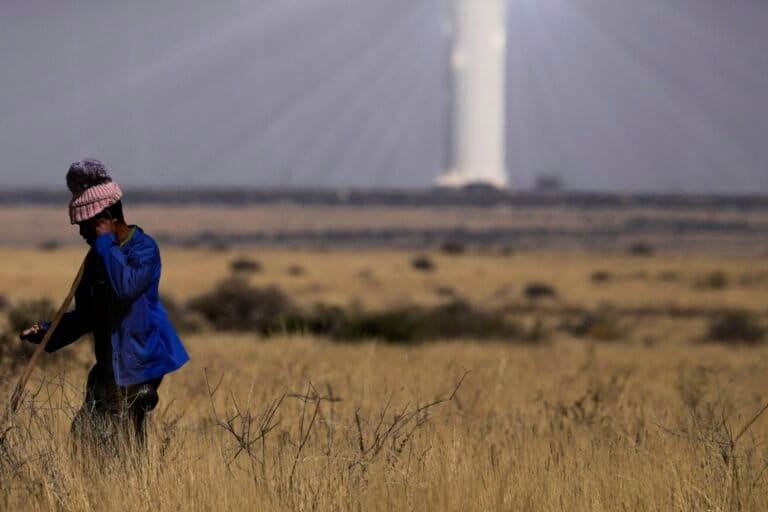 A shepherd watches livestock near Khi Solar One, a solar thermal plant that converts the sun's light energy into electricity, outside Upington, South Africa. Solar offers vast untapped potential in Africa. Image by AP Photo/Themba Hadebe.