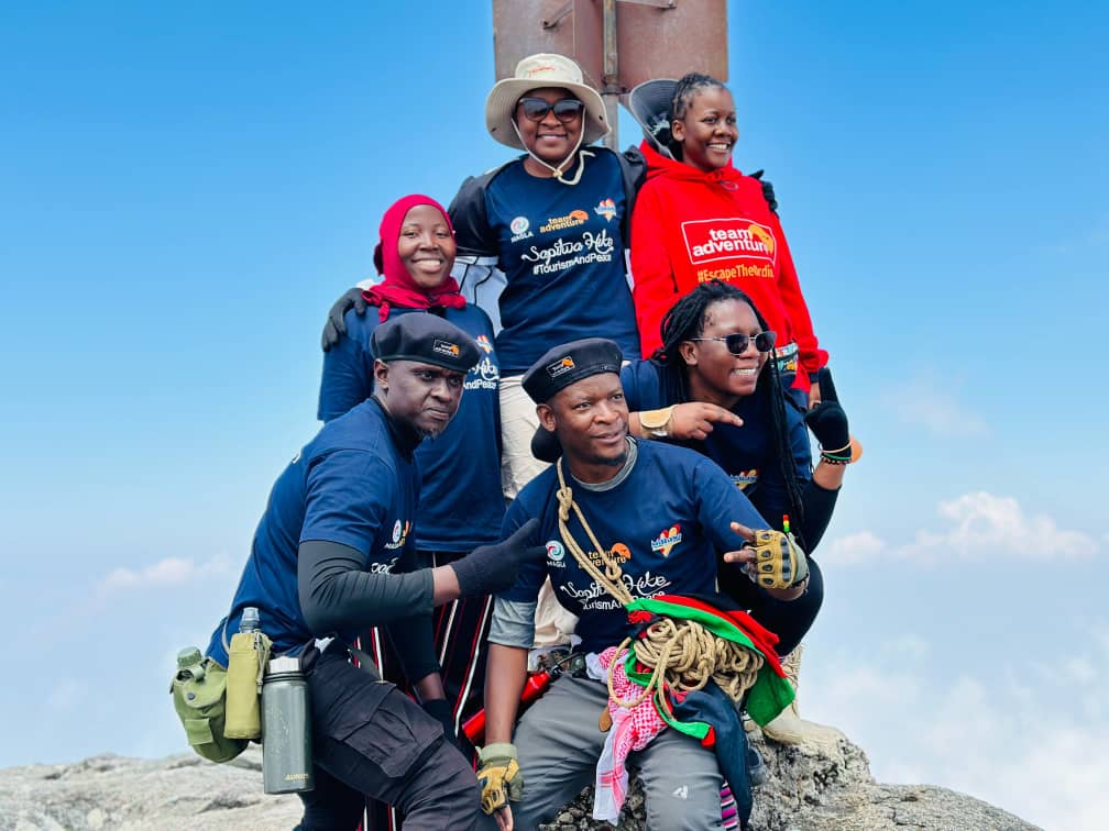 Kondwani Chamwala (center bottom) with the Minister of Tourism Vera Kamtukule (center top) and others on Sapitwa Peak, Mount Mulanje. Image courtesy of Kondwani Chamwala.