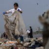 Volunteers clean up plastic and other waste materials on a beach on the Arabian Sea coast on World Environment Day in Mumbai. Environmental crises are lived experiences for young generations today — including journalists. Image by AP Photo/Rafiq Maqbool, File.