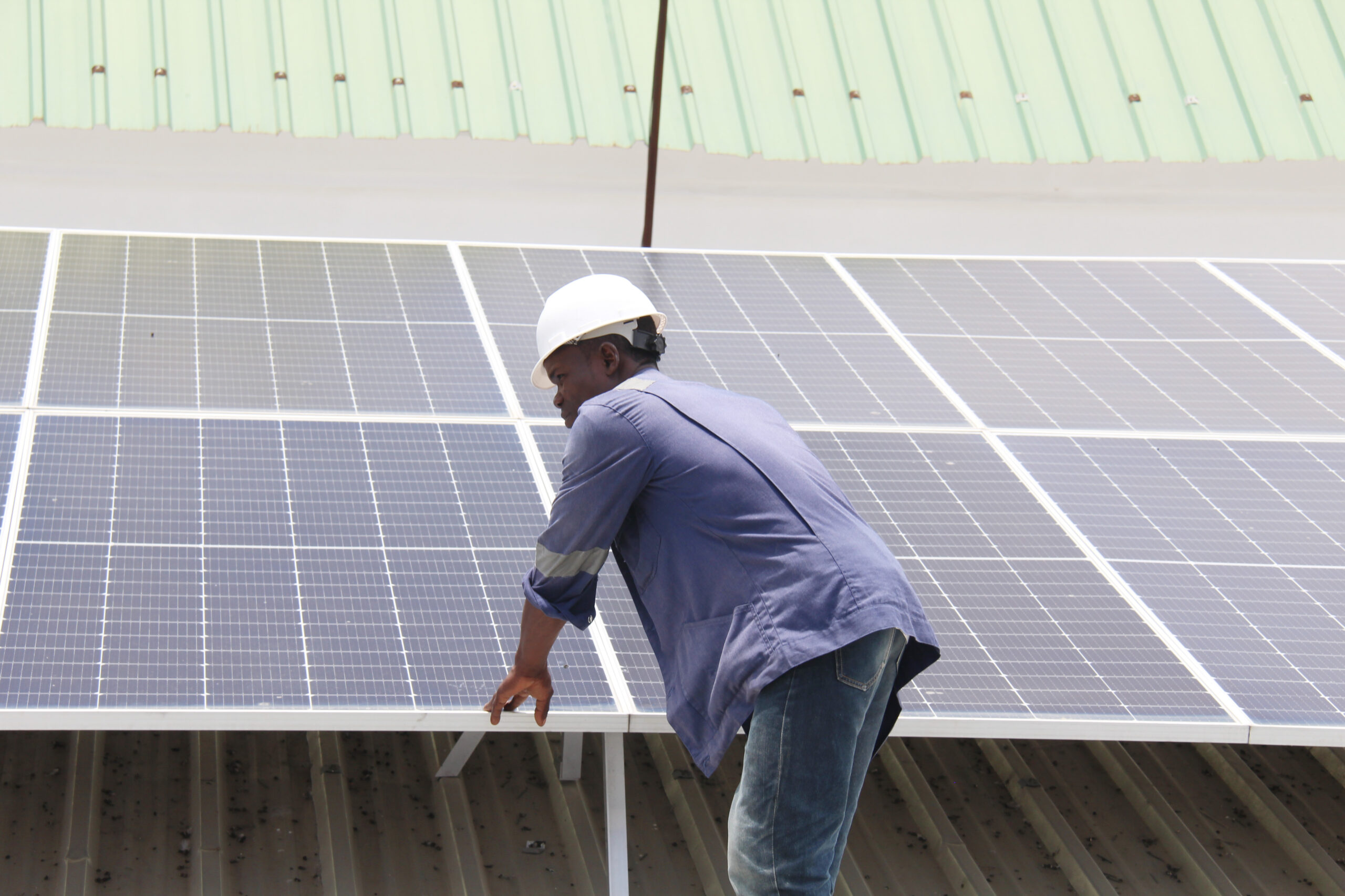 An engineer with solar panels in Cotonou, Benin. Image © UNDP Benin via Flickr.