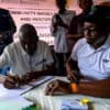 Thomas J.K.L. Koroma II, paramount chief of Sitta Chiefdom, signs the revenue-sharing carbon agreement. Image courtesy of Namati.