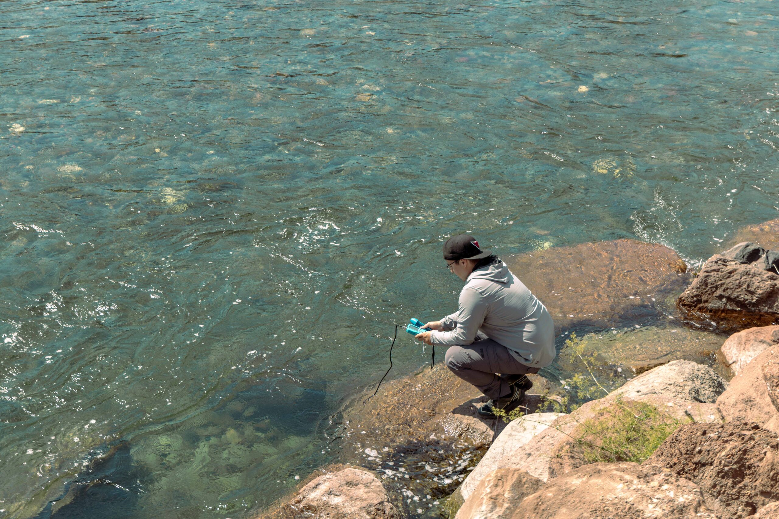 Miguel, an assistant of Samuel surveying the river by hand. Image by Boris R. Thebia.
