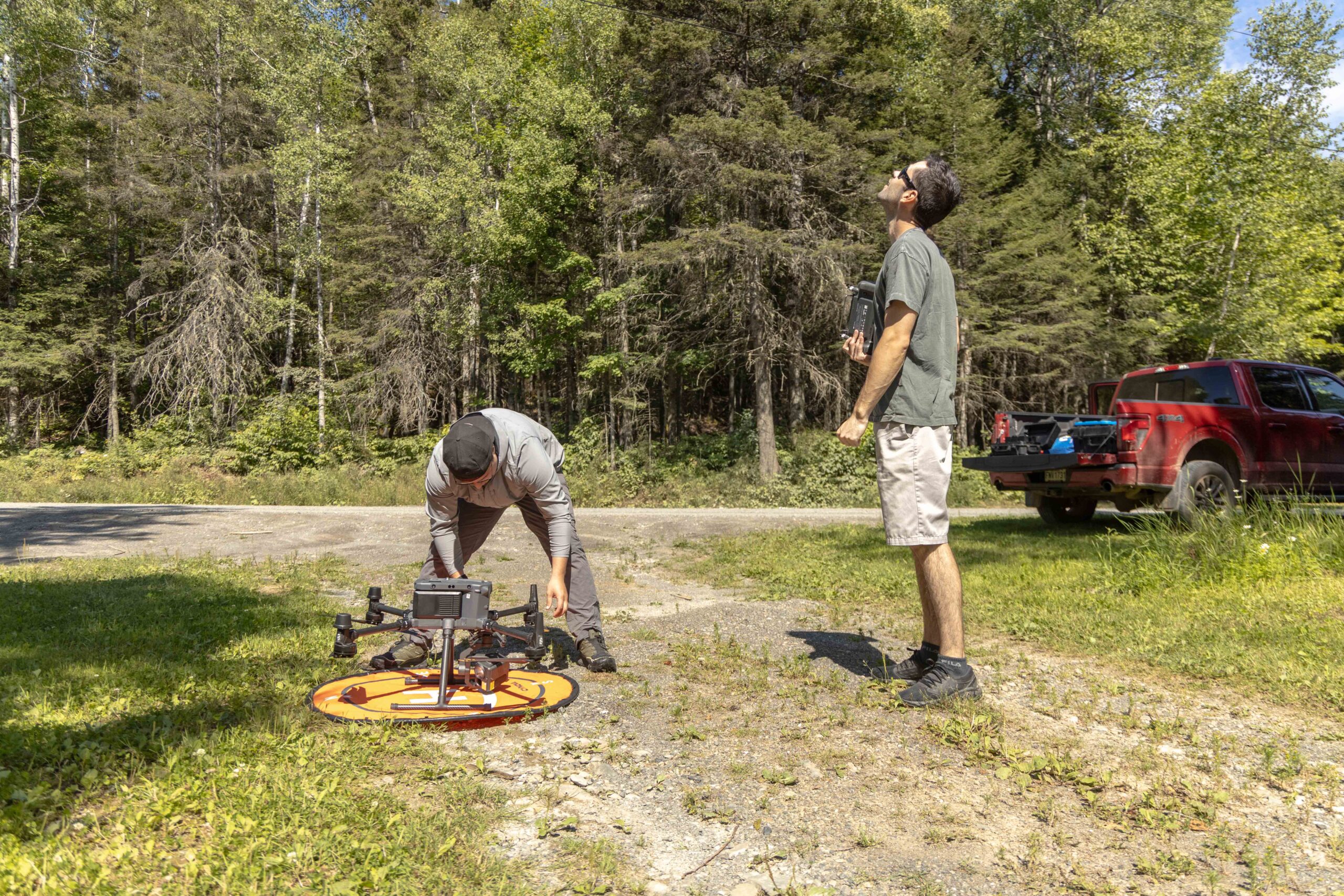 Samuel and Miguel assembling and operating the drone by the Cascapedia river. Image by Boris R. Thebia.