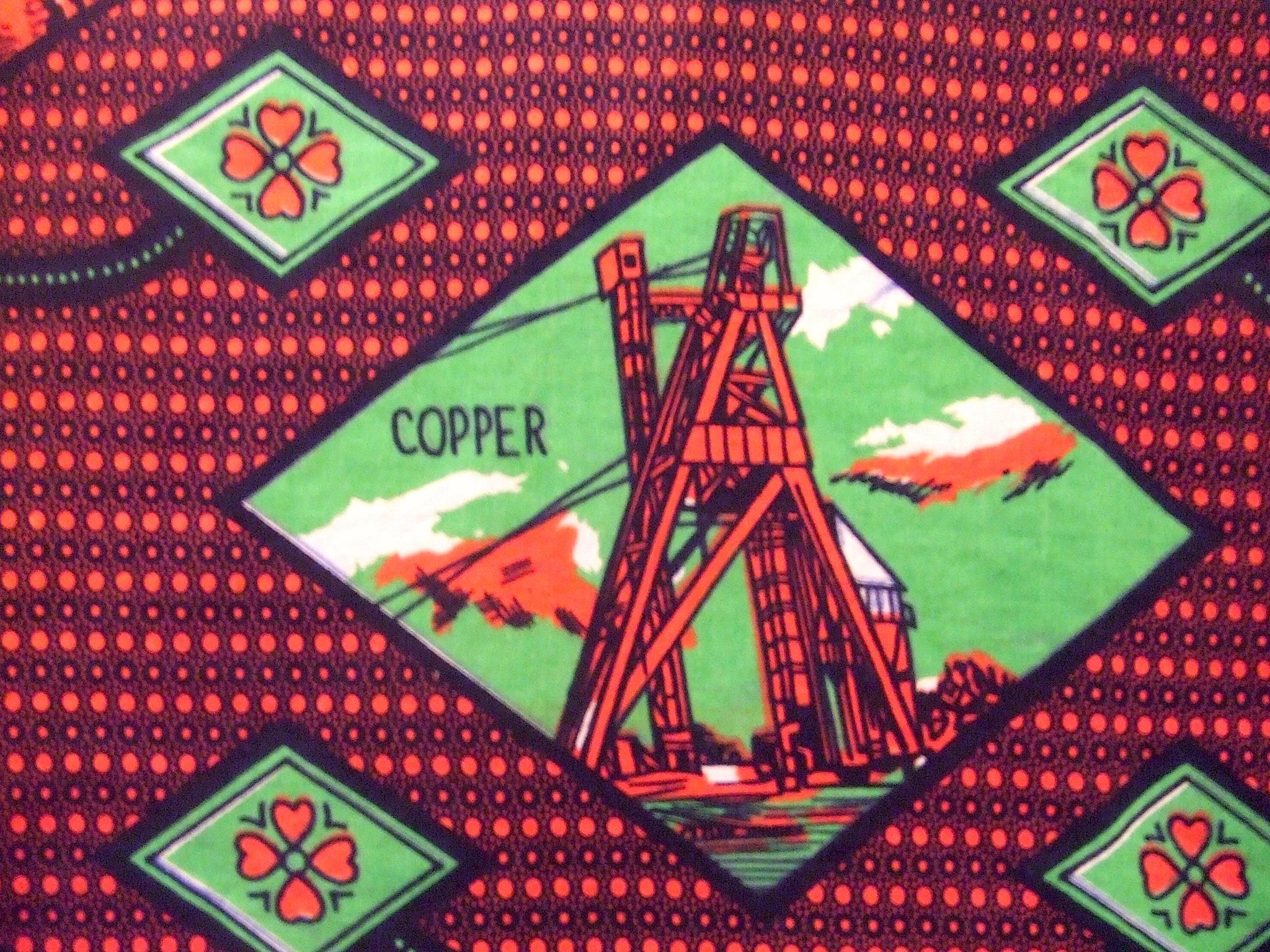 Image of a copper mine on wax print textile. Mining has long ben an engine of the Zambian economy.