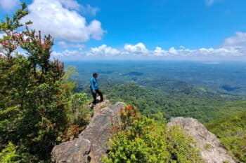 An Indigenous person gazes at the expanse of the Meratus mountains from the Hauk peak.